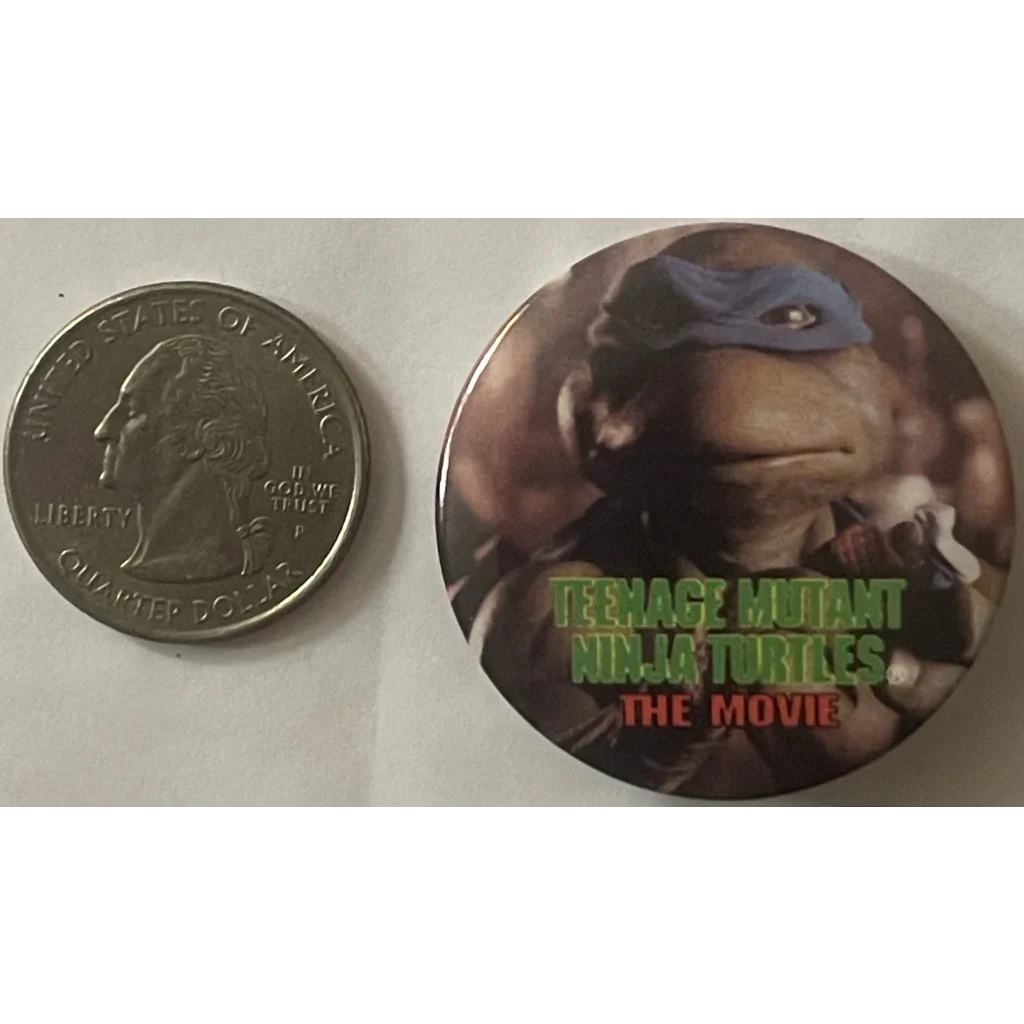 Promotional button for Teenage Mutant Ninja Turtles Movie featuring a turtle character face