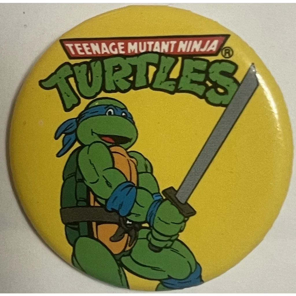 Circular button of Leonardo from Ninja Turtles movie with sword on yellow background