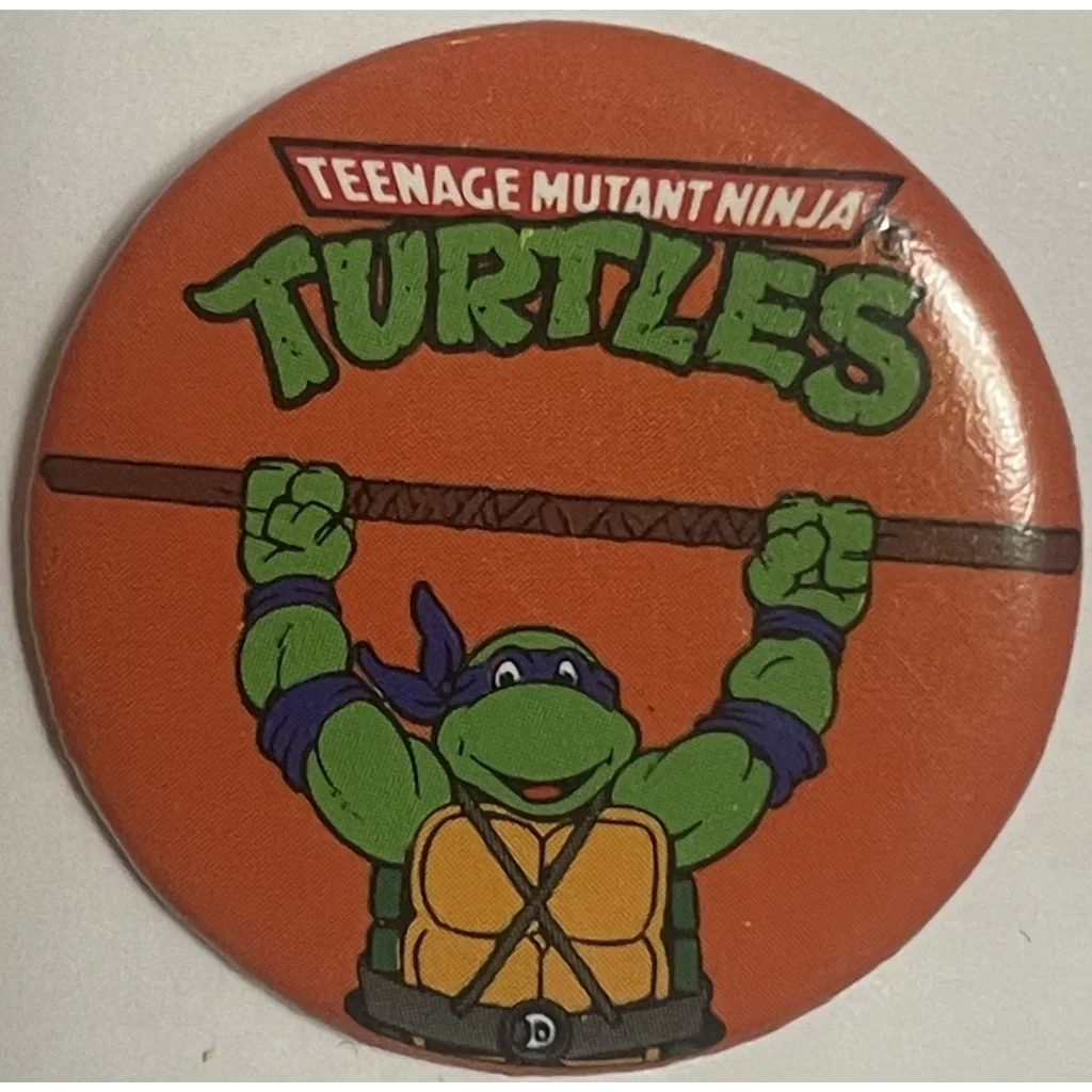 Circular button of Donatello from the Ninja Turtles Movie on an orange background