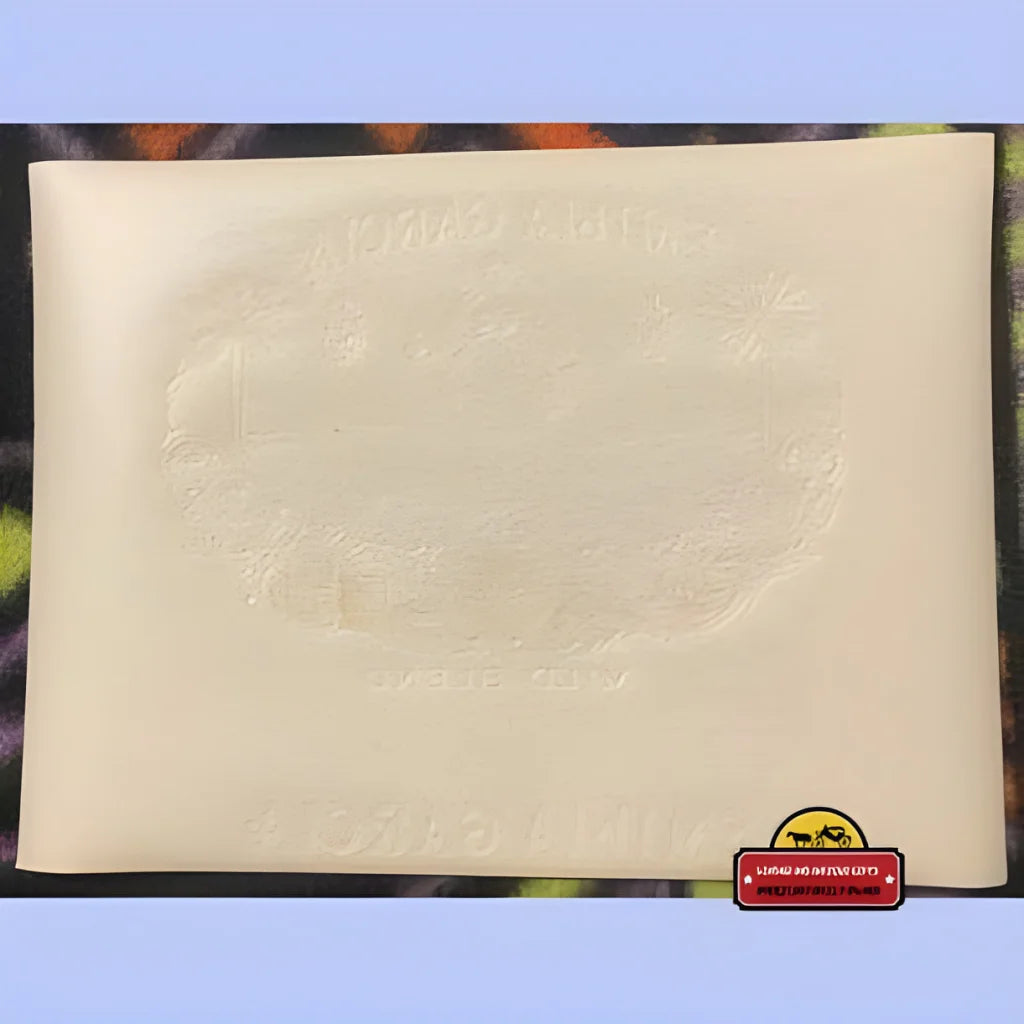 Blank off-white sheet with Emilia Garcia logo, showcasing an embossed cigar label from the 1900s