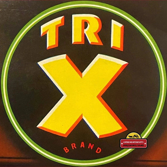 Circular logo of TRI X BRAND in bold yellow and orange on a dark background, crate label