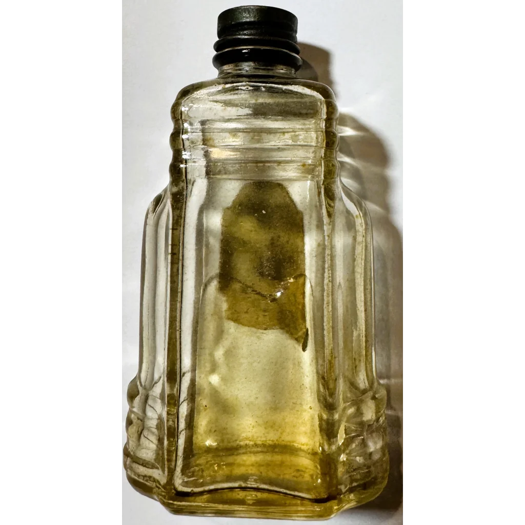 Vintage glass bottle with black cap and yellowish brilliantine inside, a unique collectible bottle antique vintage
