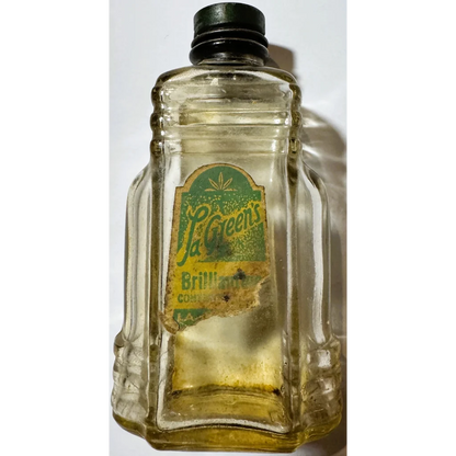 Vintage glass bottle with green label and black cap, collectible bottle brilliantine