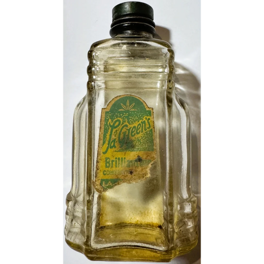Vintage glass bottle with green label and black cap, collectible bottle brilliantine