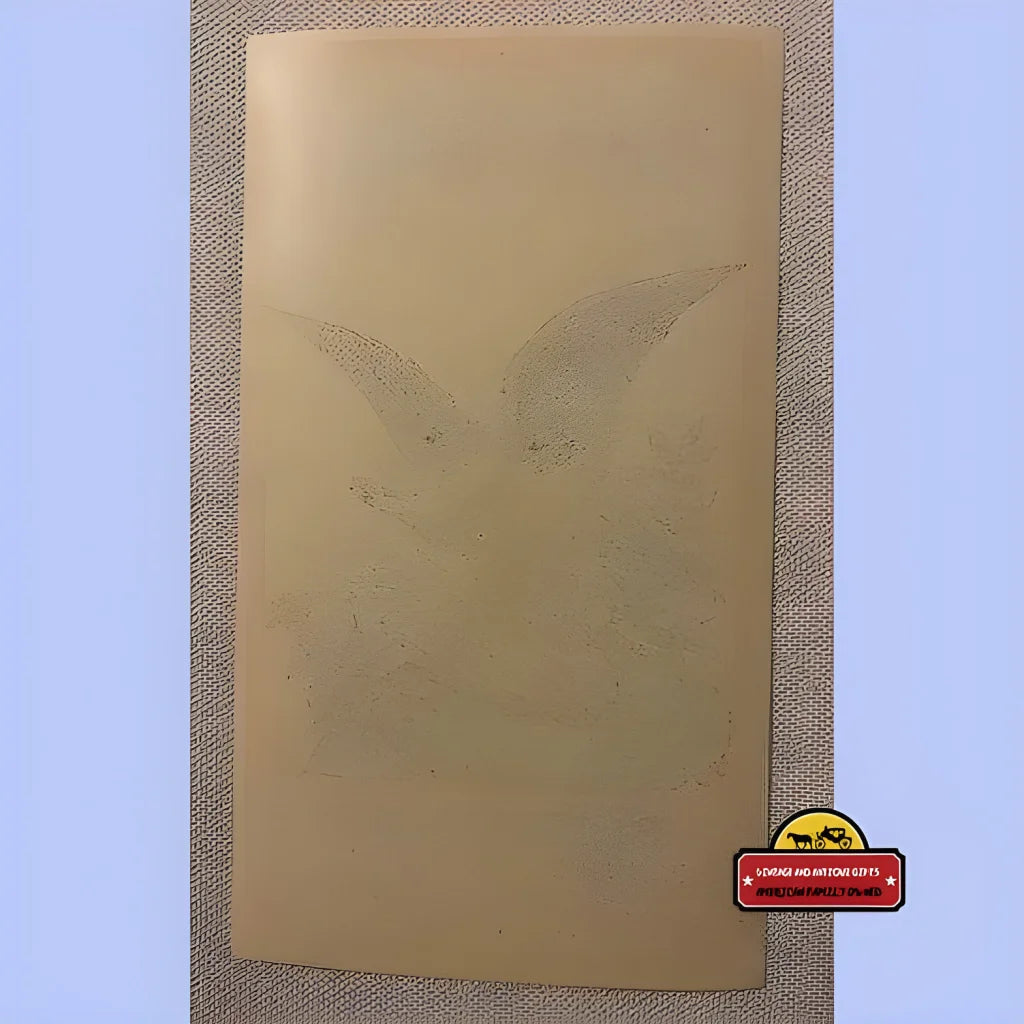 Faded angel outline on beige paper, part of the Rare Antique Vintage Jewel Broom Label