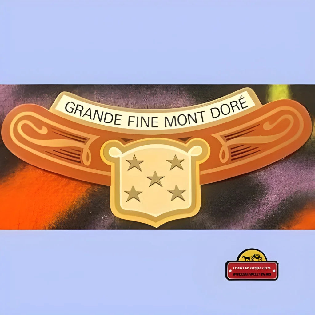 Stylized golden badge showcasing GRANDE FINE MONT DORE above a shield with five stars