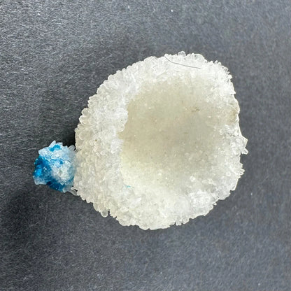Rare translucent white crystal geode with blue Cavansite accent from India
