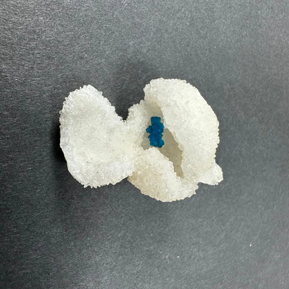 Delicate white bow with blue Cavansite gem from India