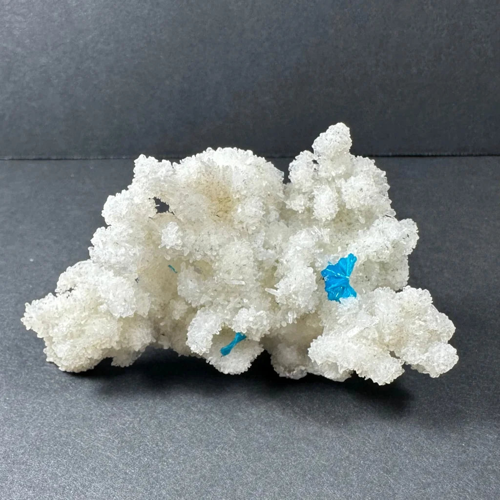 Rare blue cavansite crystal on white stilbite from India