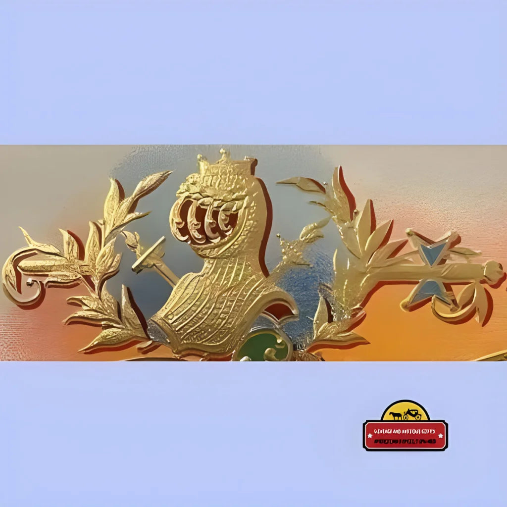 Golden emblem with a crowned bird, showcasing an embossed cigar label’s artistry