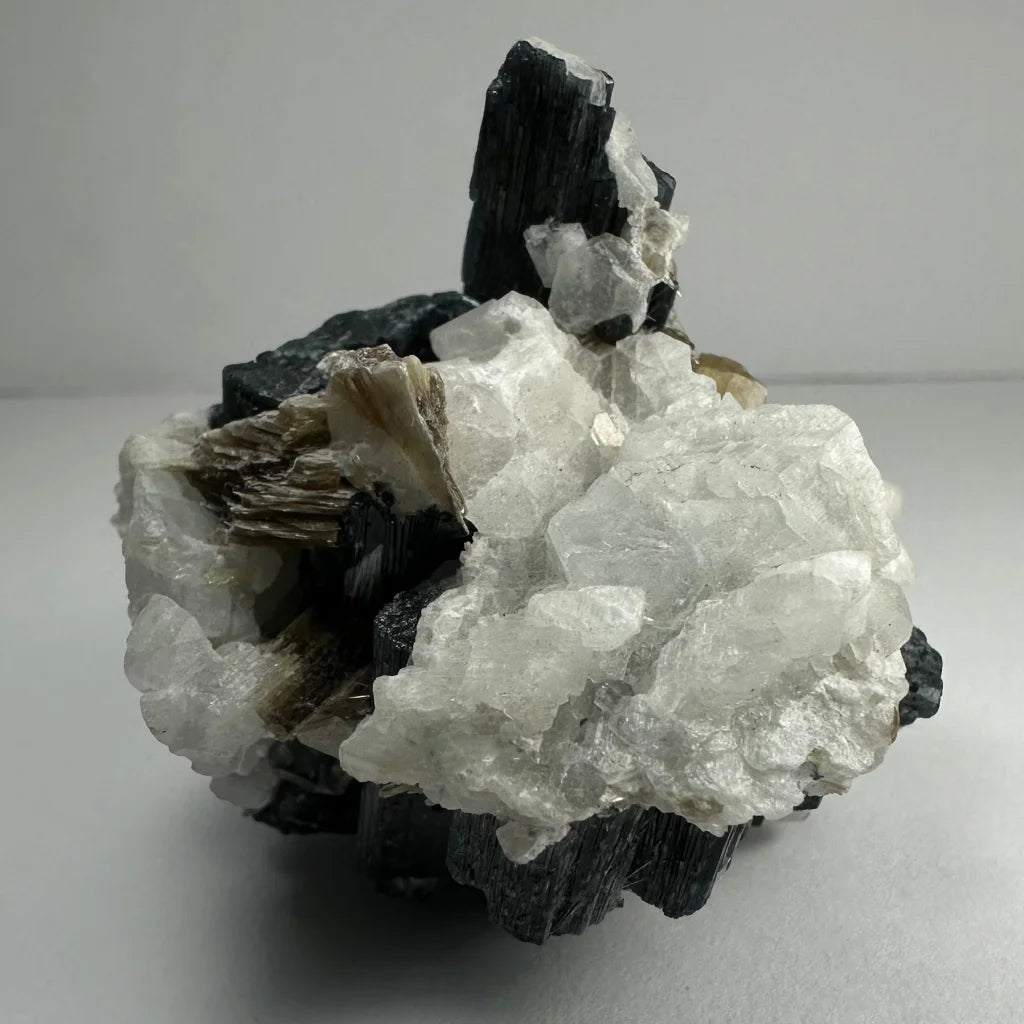 Rare green tourmaline on quartz atop albite from Brazil