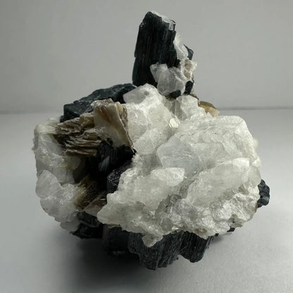 Rare green tourmaline on quartz atop albite from Brazil