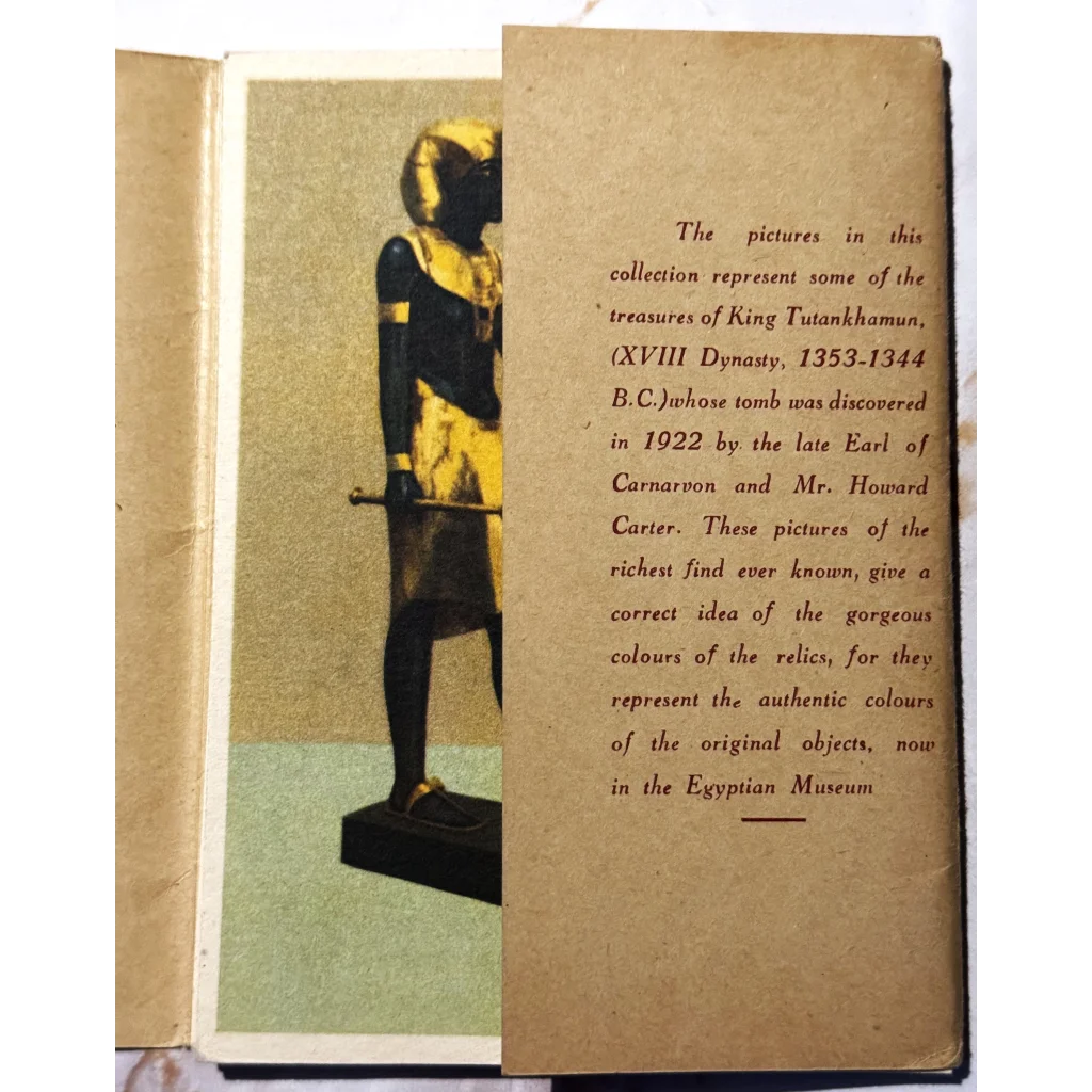 Black and gold Egyptian statue of seated deity from Rare King Tut Vintage Postcard Collection