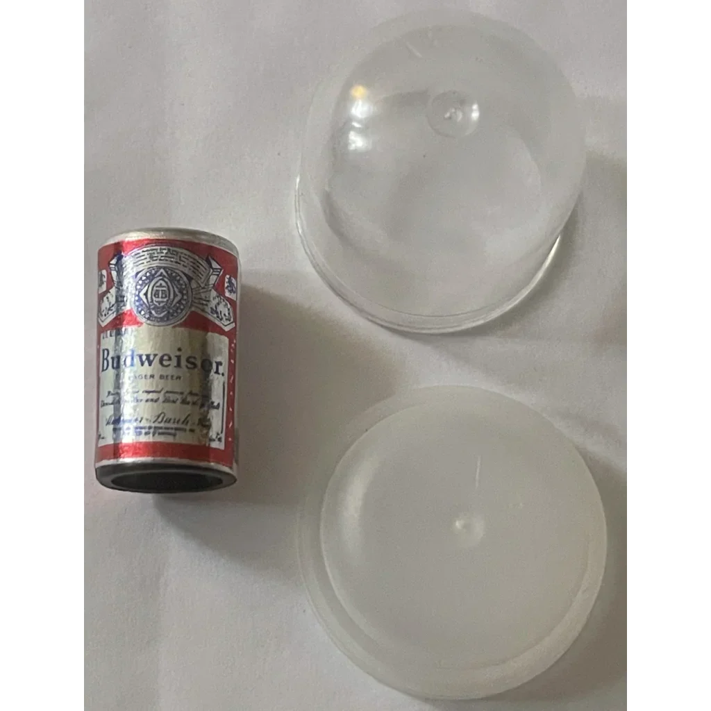 Mini Budweiser beer can next to two clear glass bowls in a vintage display