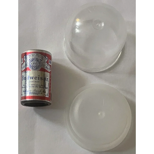 Mini Budweiser beer can next to two clear glass bowls in a vintage display