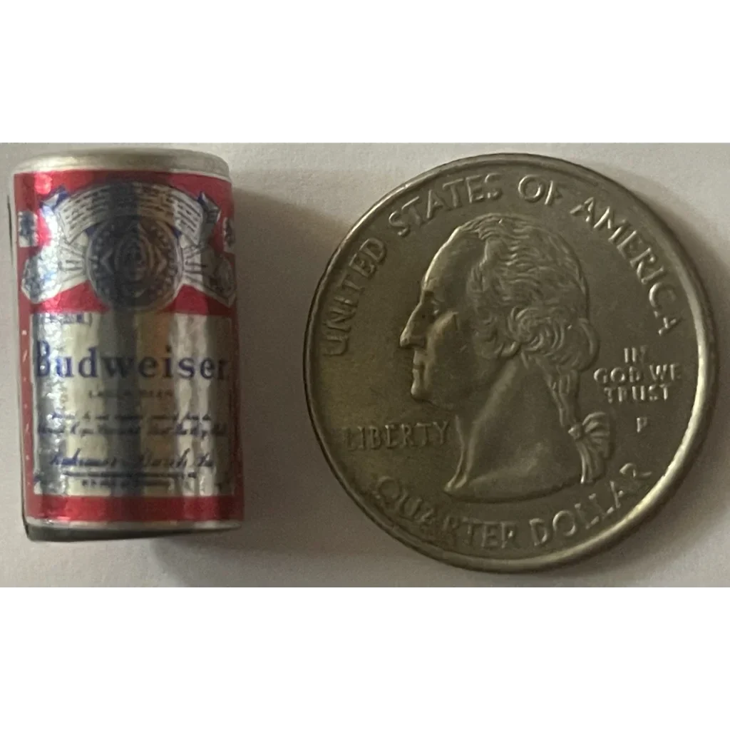 Mini Budweiser beer can next to a quarter showcasing vintage collectible charm