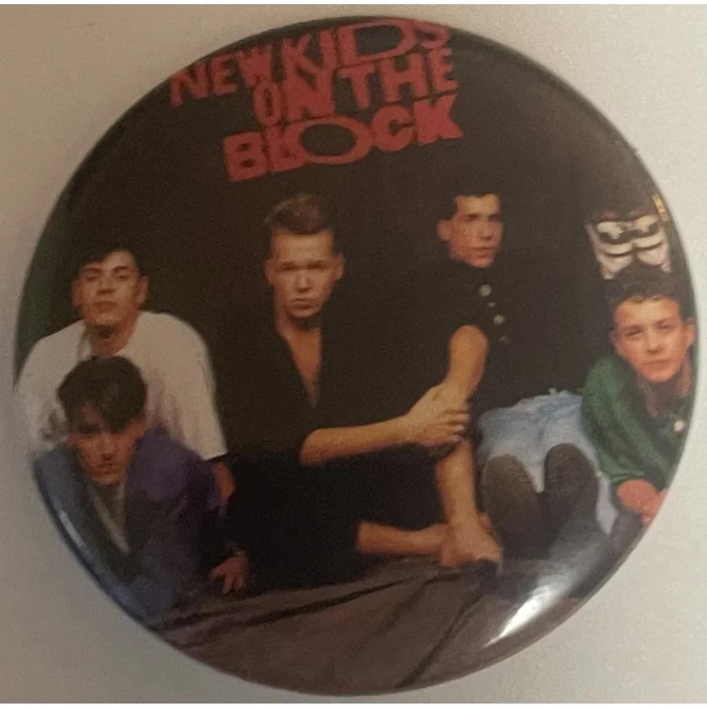 Circular vintage NKOTB pin showcasing band members for ultimate ’80s music nostalgia