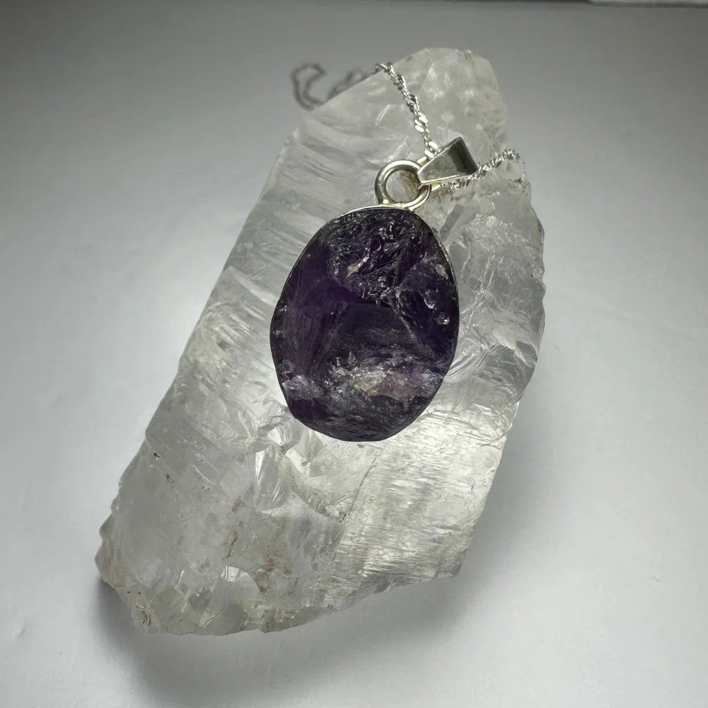 Raw amethyst sterling silver pendant with deep purple hues