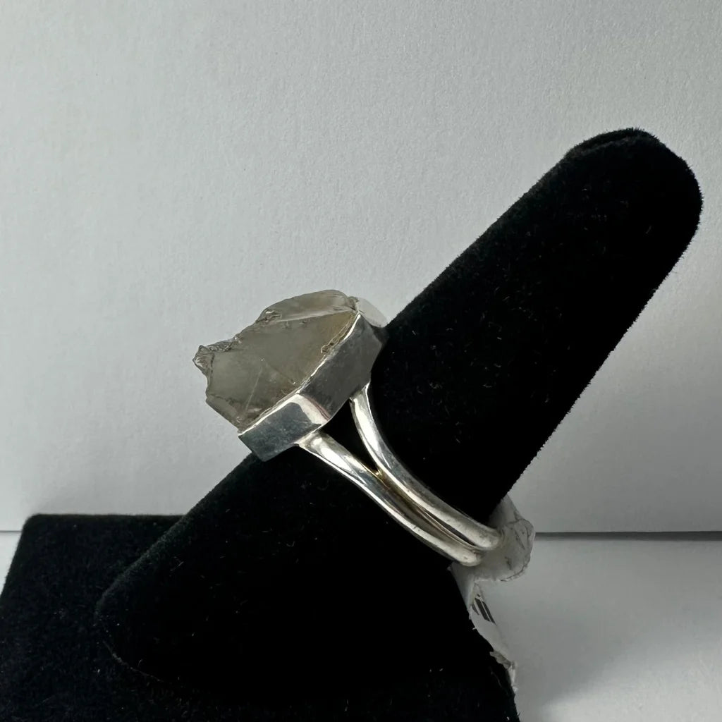 Silver quartz ring with raw translucent stone in sleek geometric band