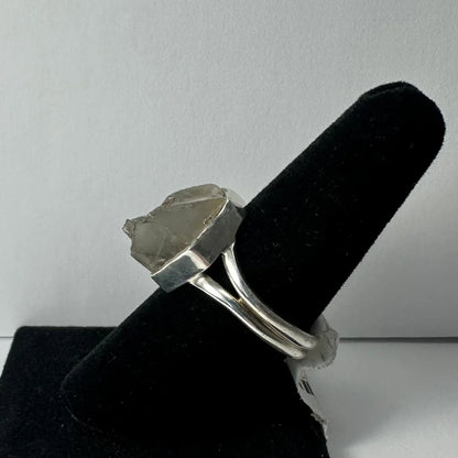 Silver quartz ring with raw translucent stone in sleek geometric band