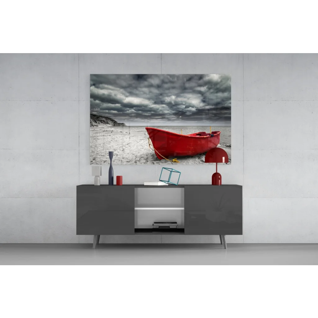 Vibrant red boat on sandy beach under moody clouds wall art print