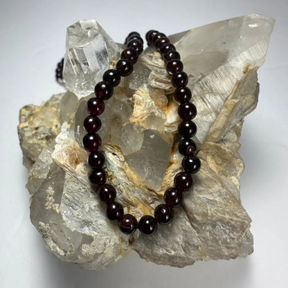 Elegant red garnet round bead necklace on quartz crystals