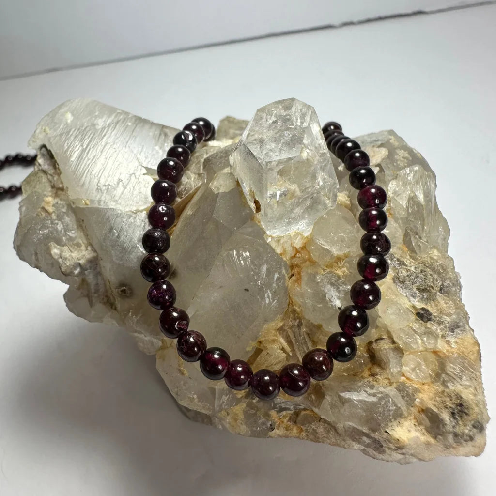 Red garnet round bead necklace on quartz crystals