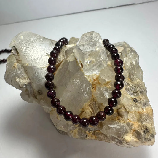 Red garnet round bead necklace on quartz crystals