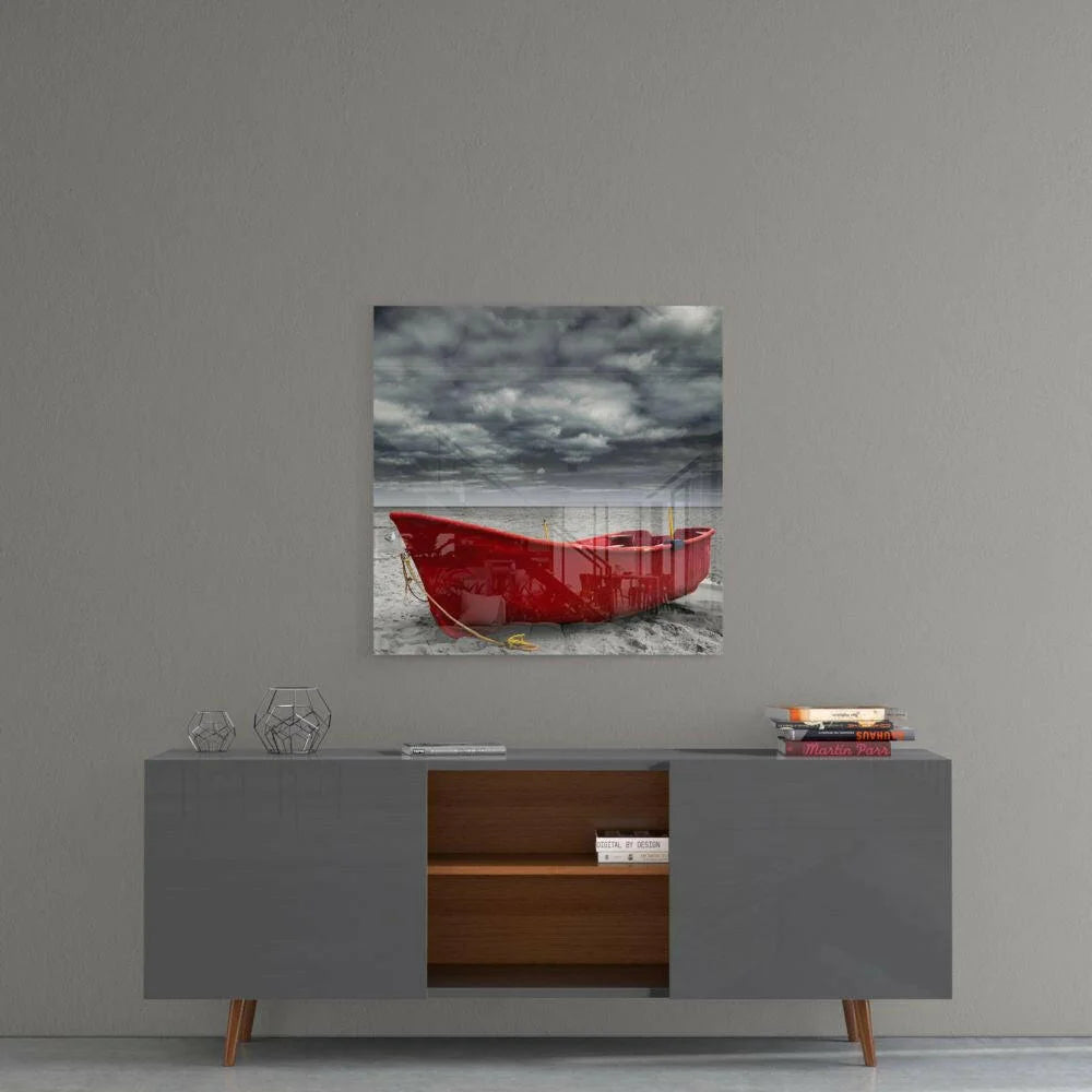 Red boat on sandy shore under stormy skies, glass wall art print