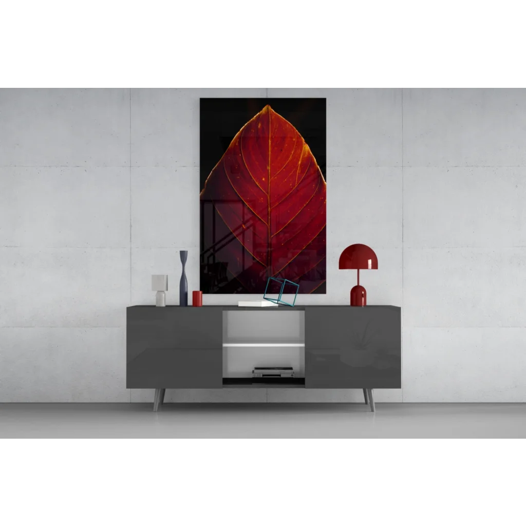 Vibrant red leaf glass wall art with golden veins on black background