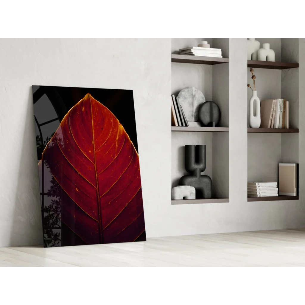 Vibrant red leaf with golden veins in stunning glass wall art