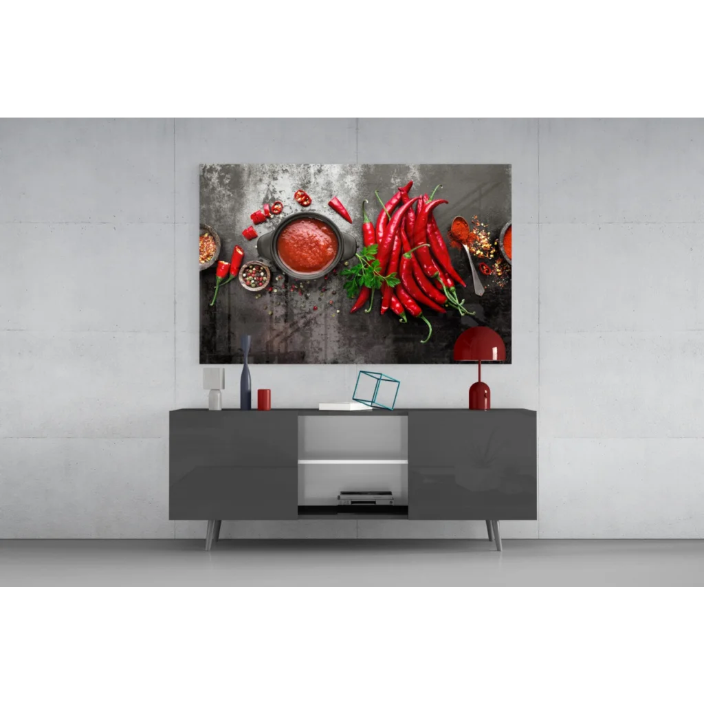 Vibrant red chili pepper glass wall art on dark textured surface