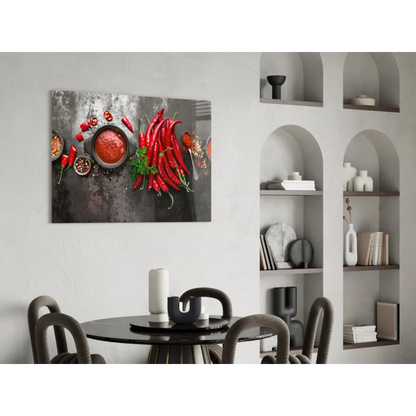 Vibrant red chili pepper glass wall art on dark textured surface