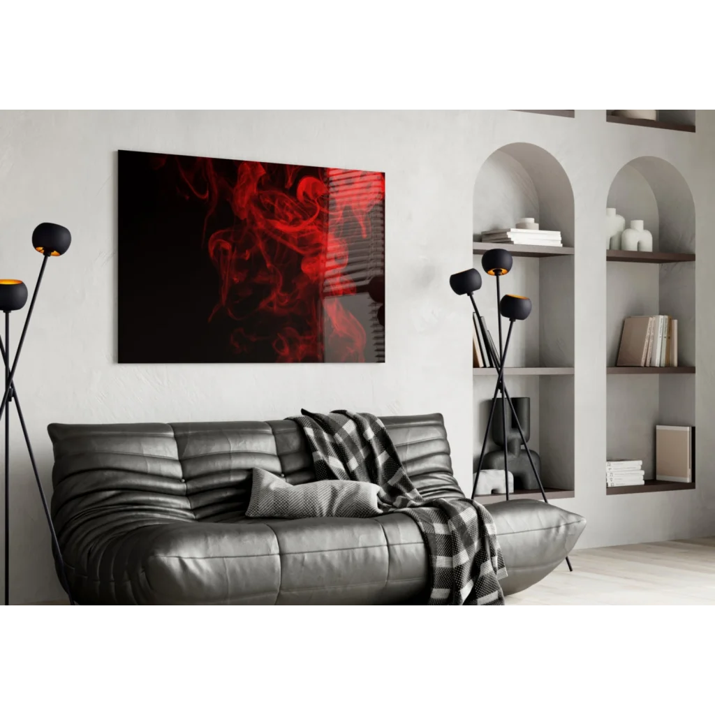 Black leather sofa with plaid throw and red smoke glass wall art