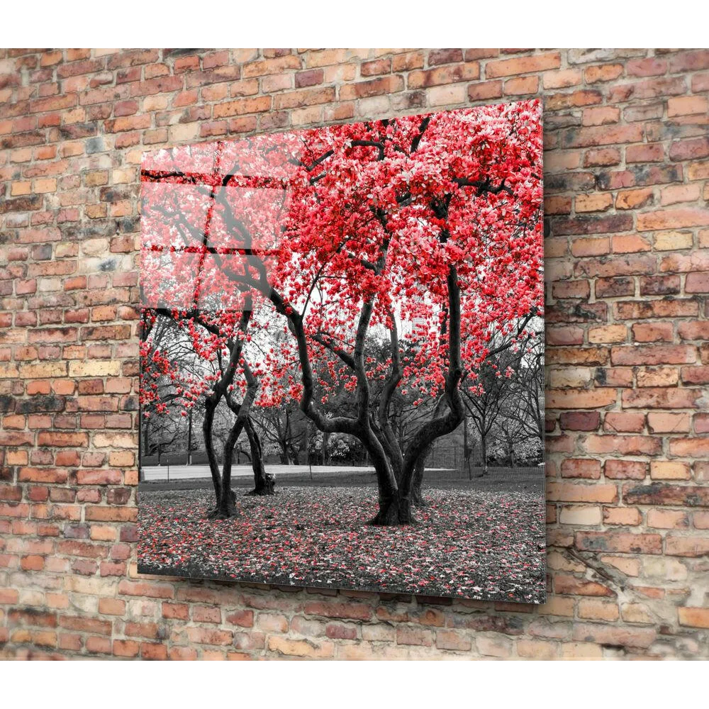 Vibrant red blossom glass wall art on glossy panel against monochrome brick wall