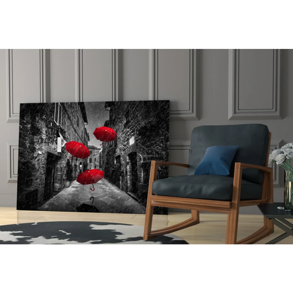 Black-and-white canvas wall art of red umbrellas in cobblestone alley