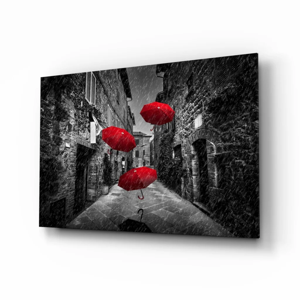 Vibrant red umbrellas in black-and-white cobblestone alley wall art