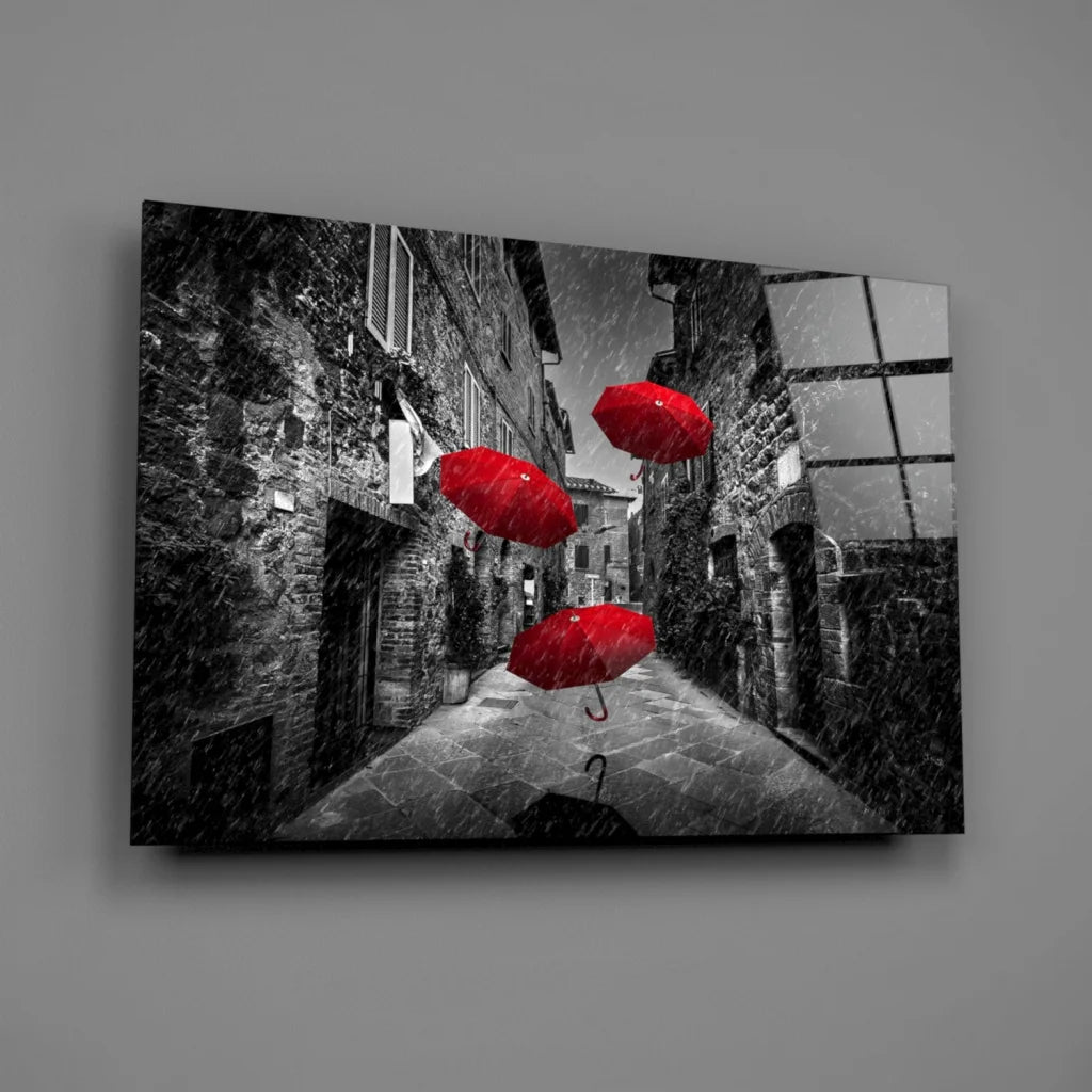 Vibrant red umbrellas in black-and-white cobblestone alley wall art