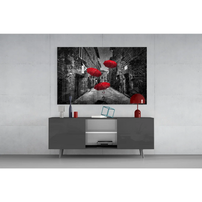 Vibrant red umbrellas in black-and-white cobblestone alley wall art