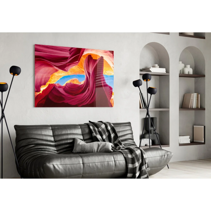 Vibrant red canyon glass wall art with swirling orange and blue sky archway