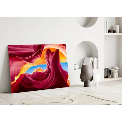 Vibrant red canyon glass wall art with swirling sandstone and blue sky archway