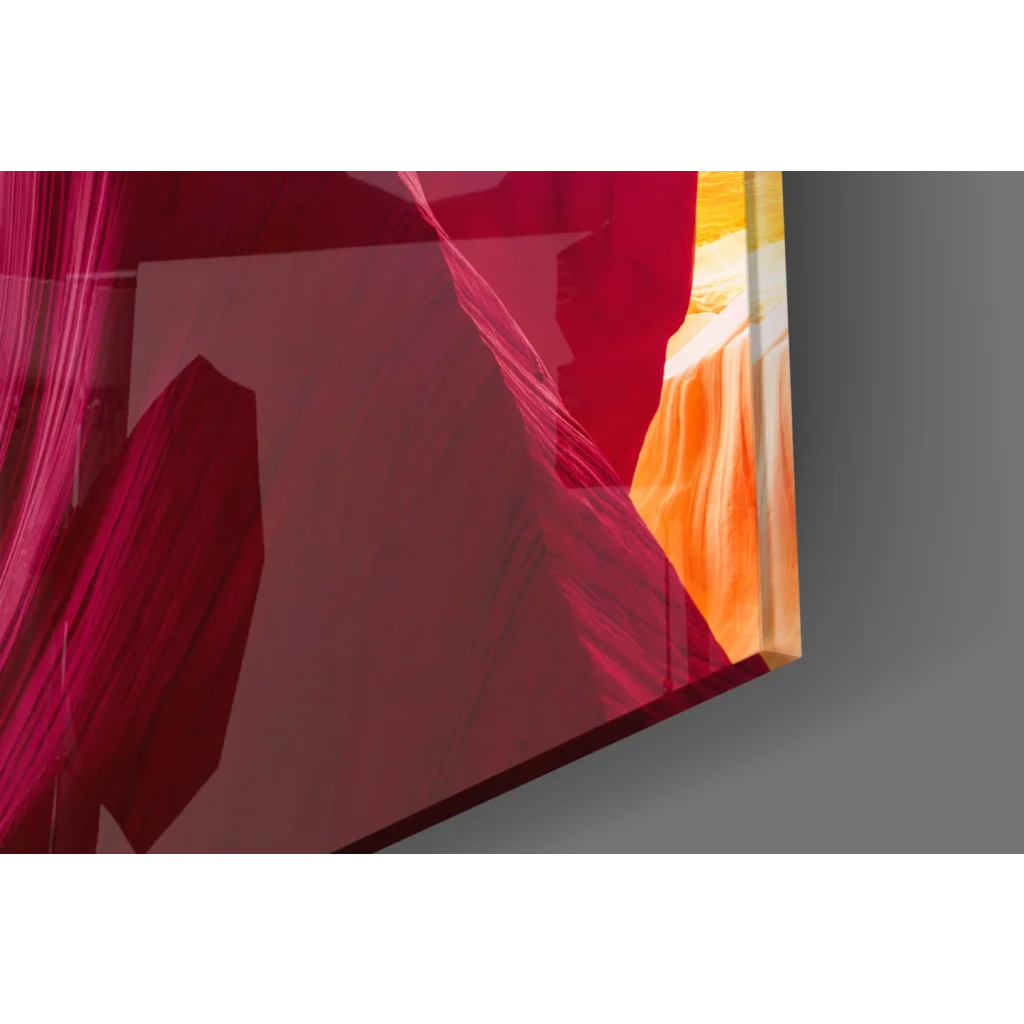 Vibrant red canyon glass wall art with orange hues and blue sky archway