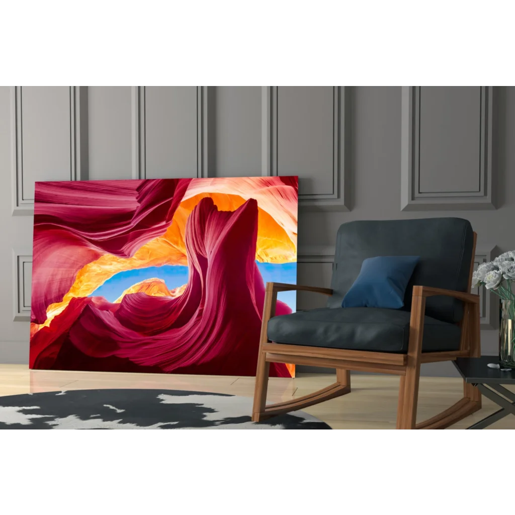 Vibrant glass wall art of swirling red canyon and blue sky archway