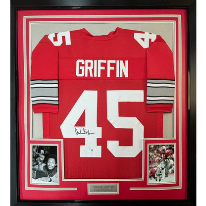 Framed red football jersey with white lettering and polka dots