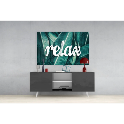 Teal tropical relax glass wall art with bold white relax lettering on leaves