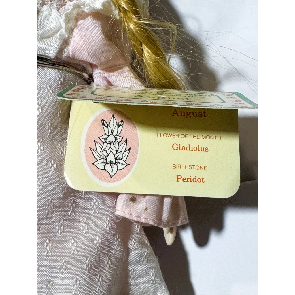 Retro vintage porcelain August doll with peridot necklace from remember collection