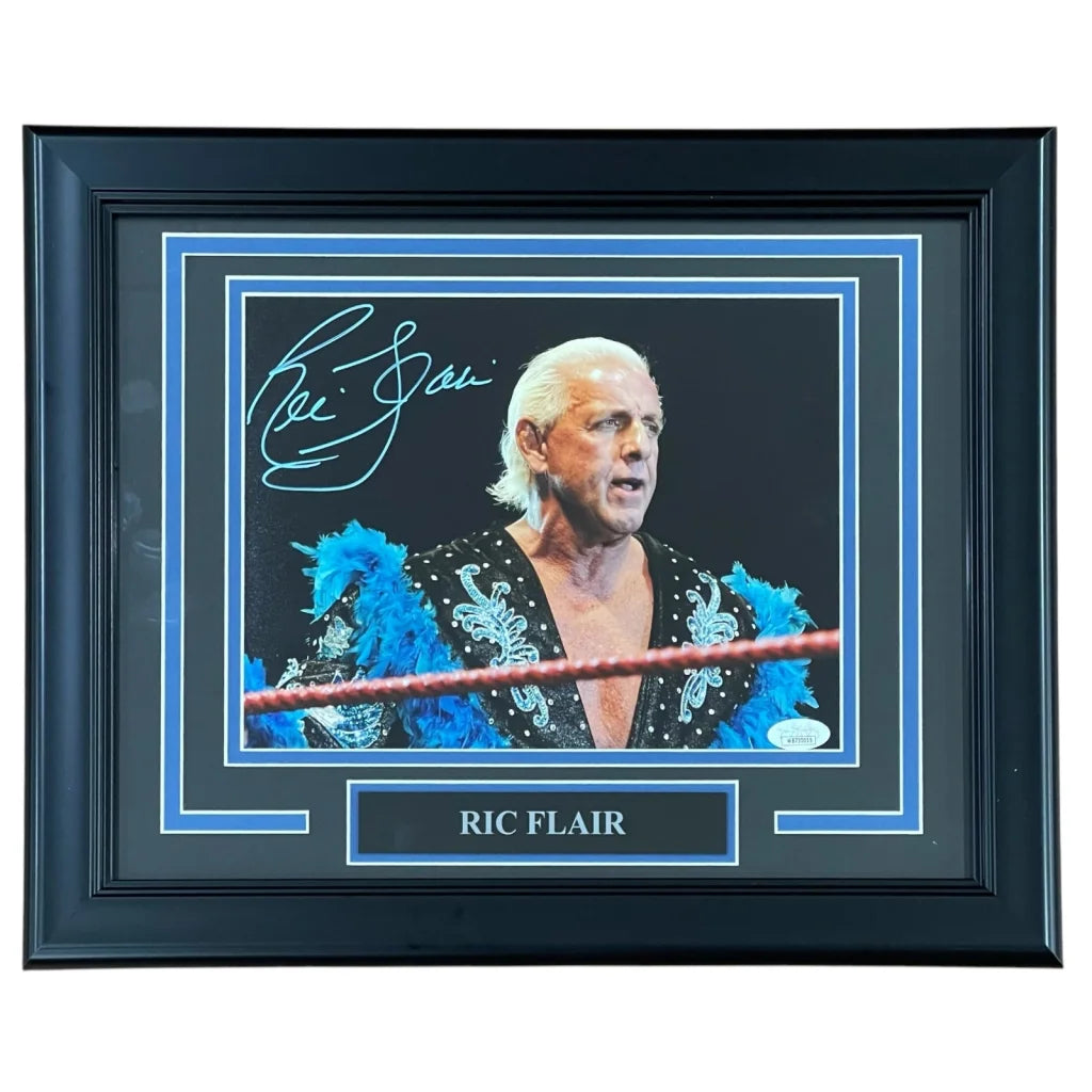 Ric Flair autographed wrestling photo in blue feathered robe, framed