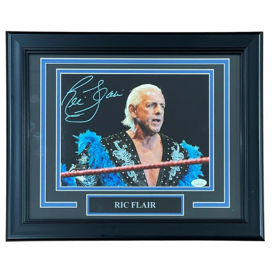 Ric Flair autographed wrestling photo in blue feathered robe, framed