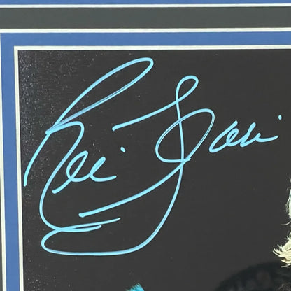 Ric Flair autographed wrestling photo with blue pen on black background