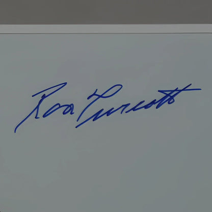 Blue ink signature of ronald reagan on light gray surface in deluxe framed 11x14 ron turcotte photo
